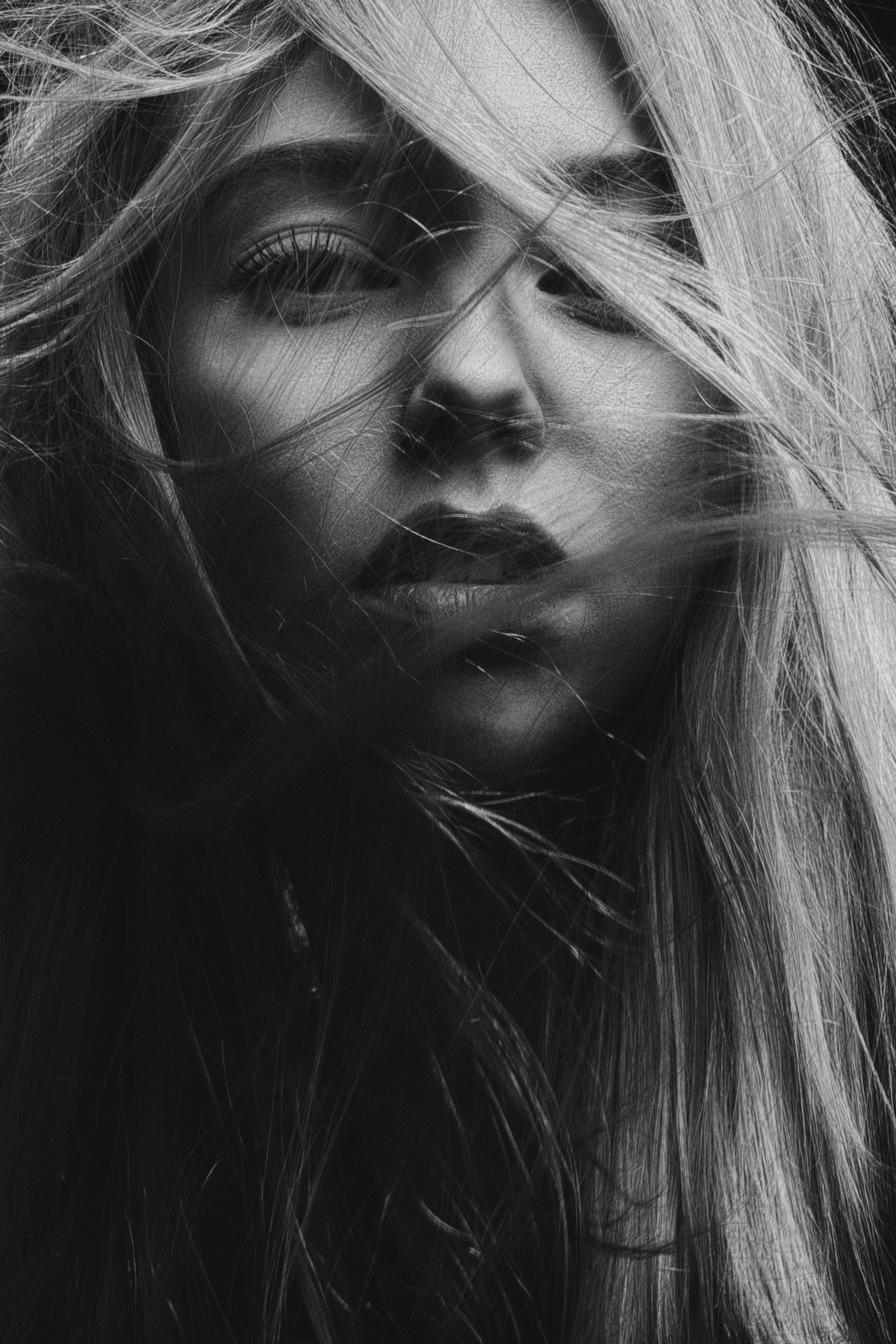 A dramatic black and white editorial portrait